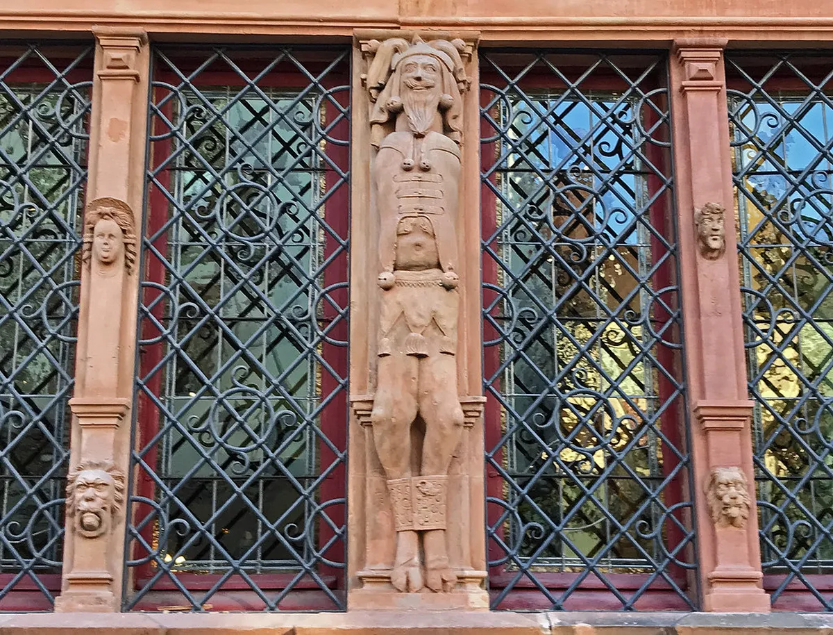The carved facade of the Maison des Têtes (House of Heads) in Colmar, France, with its 106 grotesque heads and oriel window