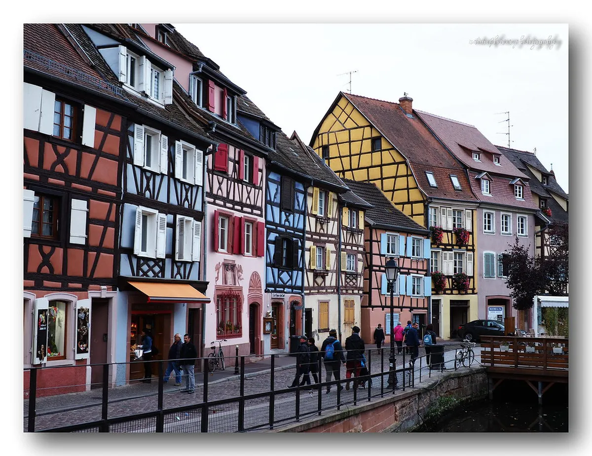 Colmar's Quai de la Poissonnerie: timber-framed houses reflected in the Lauch river canal