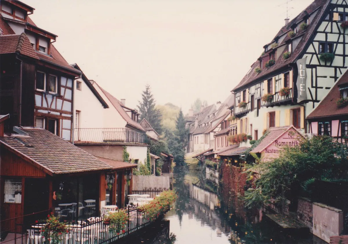 Colmar little tourist train winding through historic old town streets
