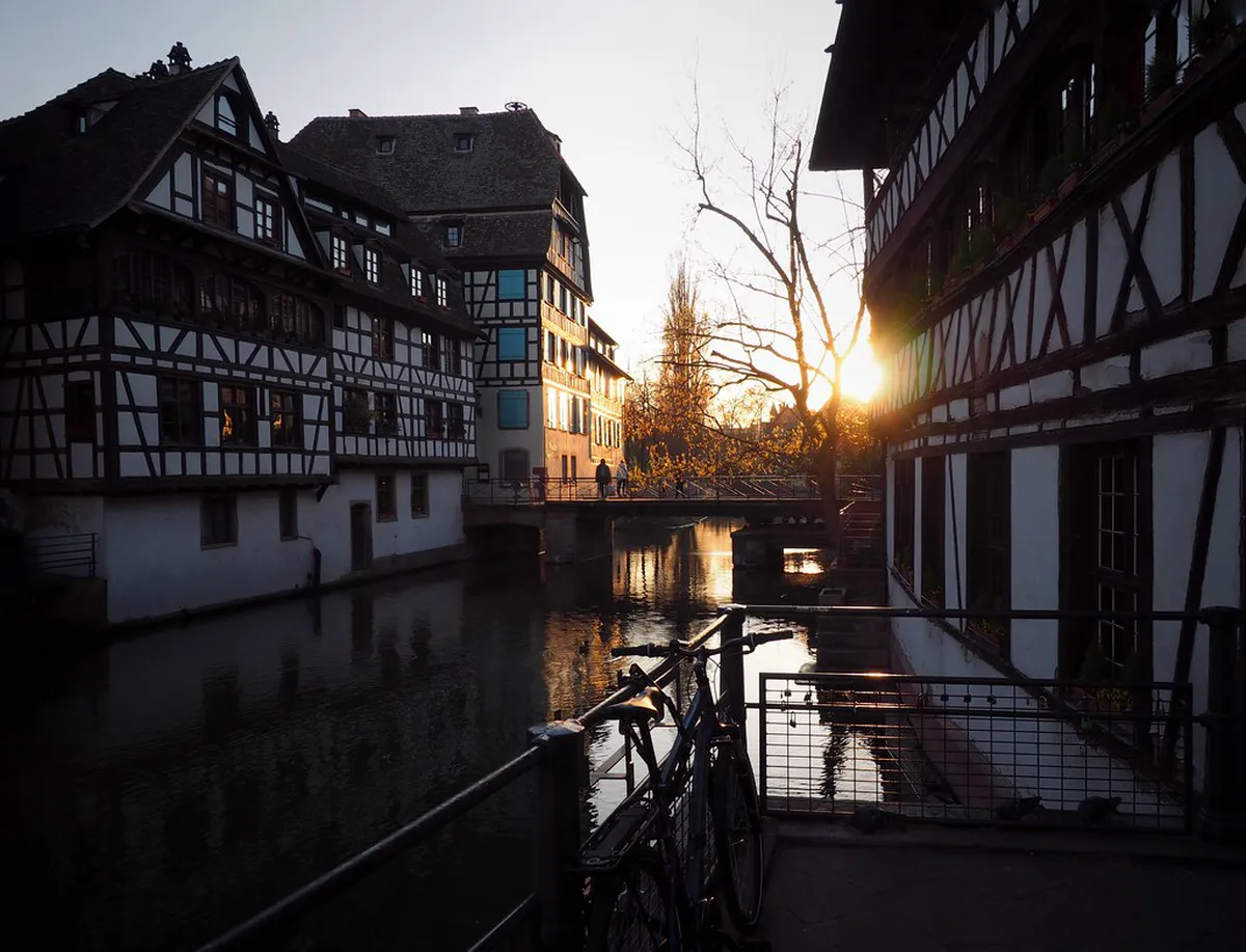Half-timbered houses reflecting in canal waters of La Petite France