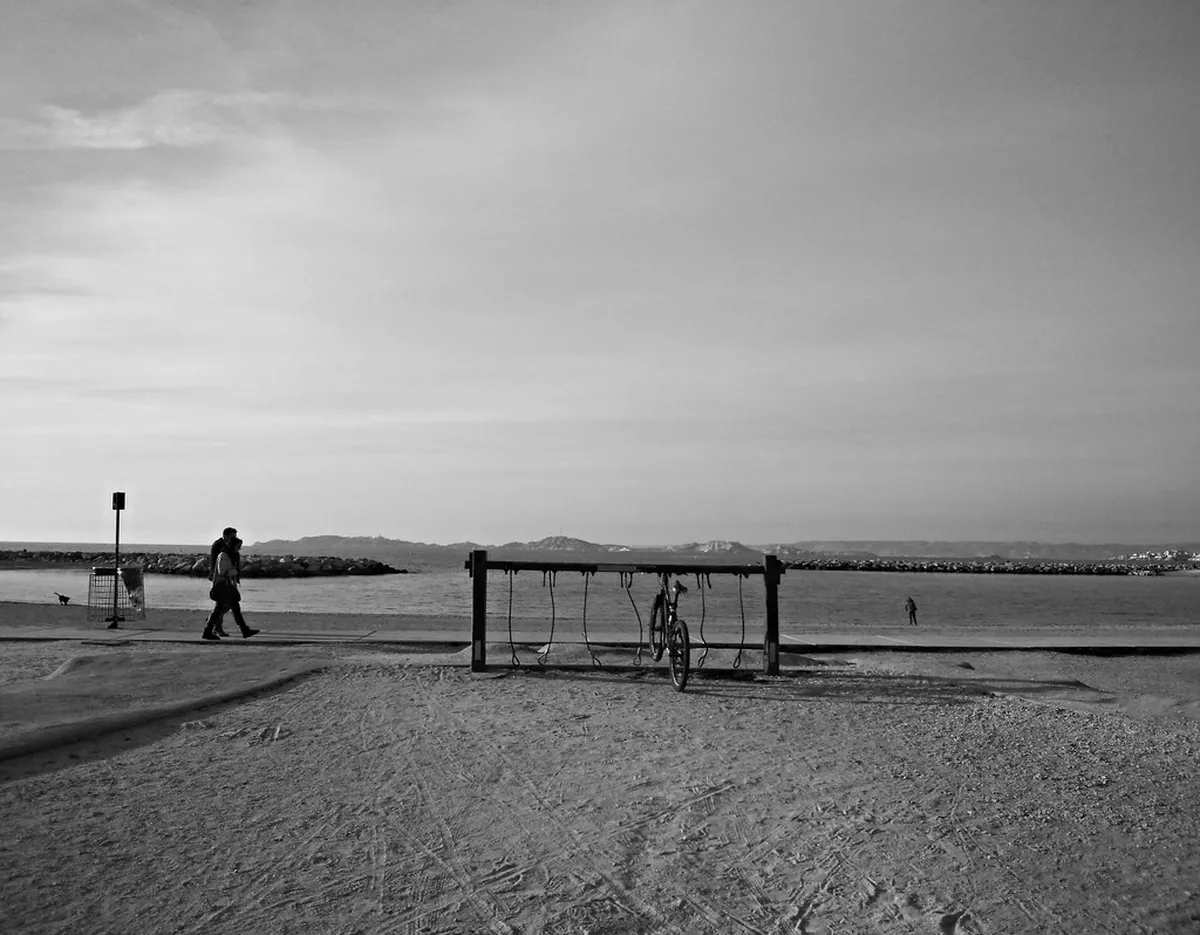 Plages du Prado sandy beach with sculptures and summer crowds in Marseille